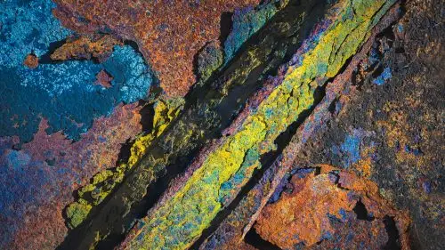 Vibrant patterns of rust and oxidation create a striking abstract composition.